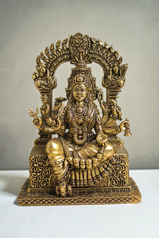 Rigvedaa™ brass idol of Goddess Mariamman seated, adorned with jewelry and multiple arms, 6 inches tall.