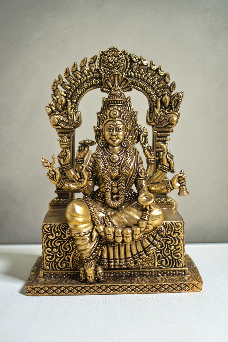 Rigvedaa™ brass idol of Goddess Mariamman seated, adorned with jewelry and multiple arms, 6 inches tall.
