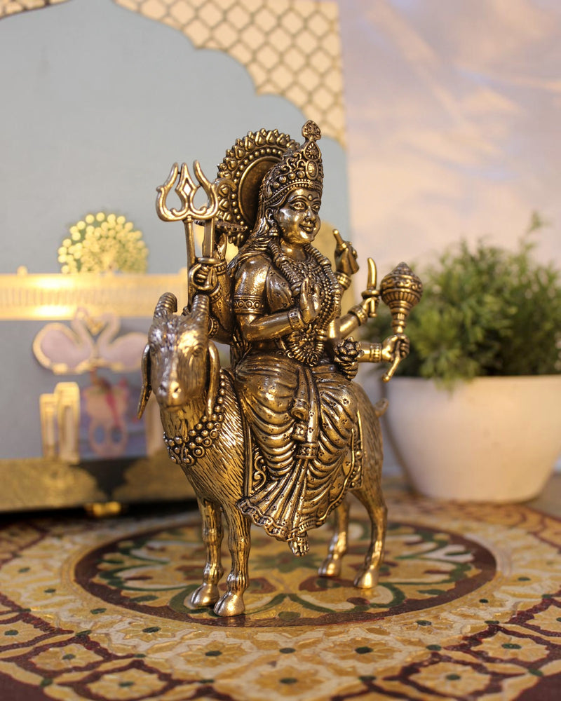 Rigvedaa	exttrademark
 Brass Meldi Maa statue on goat, a protective folk goddess sculpture with intricate details and golden patina.