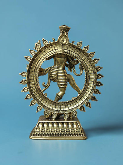 Rigvedaa™ brass Nataraja statue showing Lord Shiva in cosmic dance within a detailed ring of fire against blue backdrop