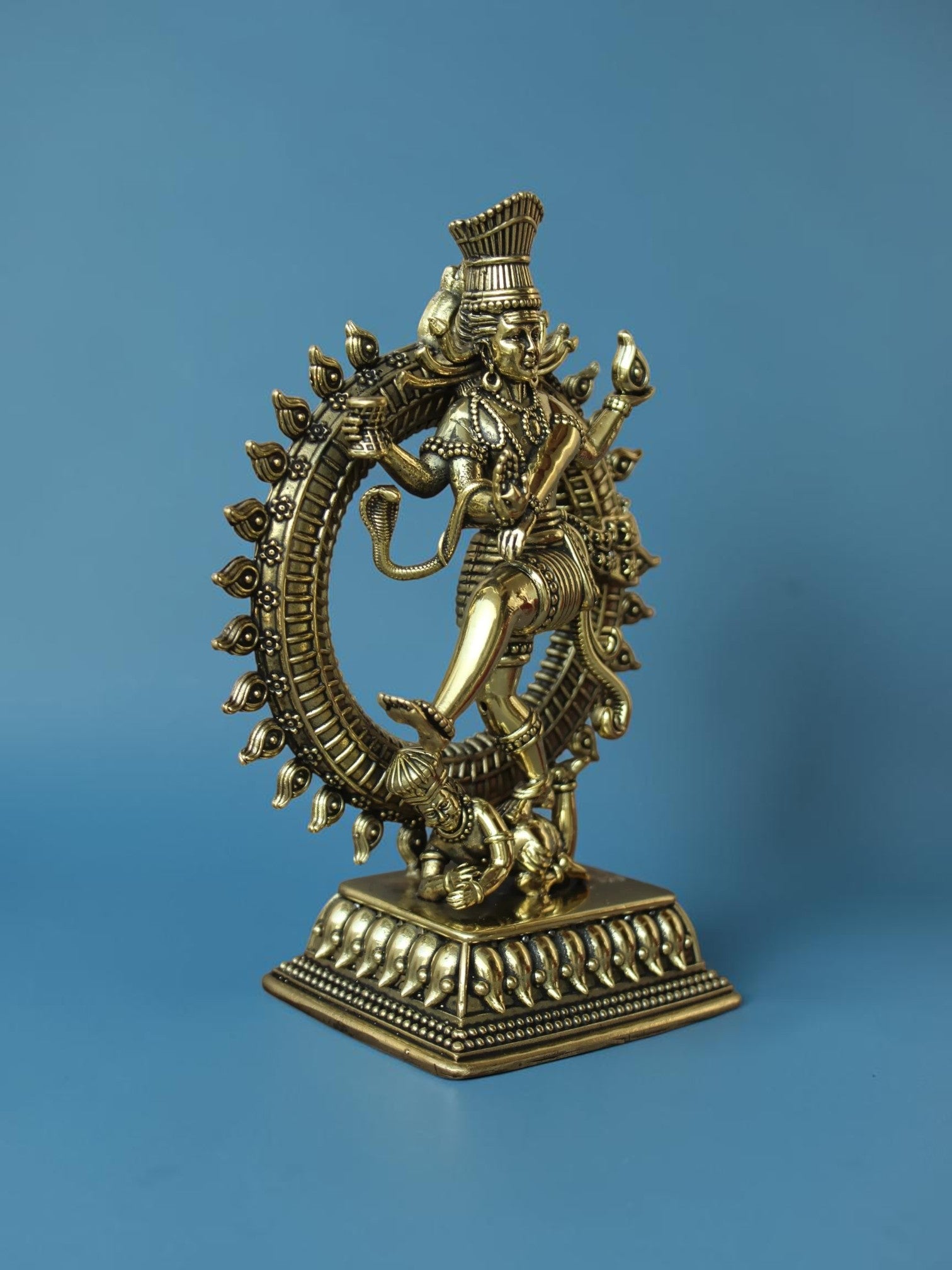 Rigvedaa™ golden brass Nataraja statue featuring Lord Shiva in a cosmic dance with intricate ring of fire detailing.