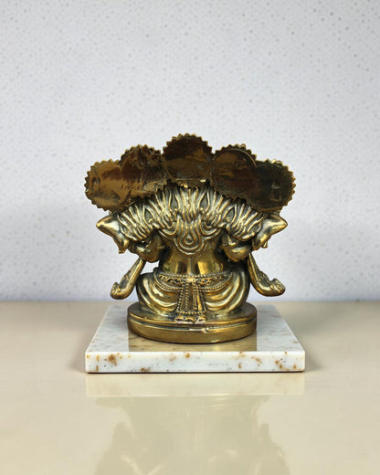 Rigvedaa™ Brass Panchmukhi Ganesha statue with five faces, intricate details, golden patina, on a marble base.