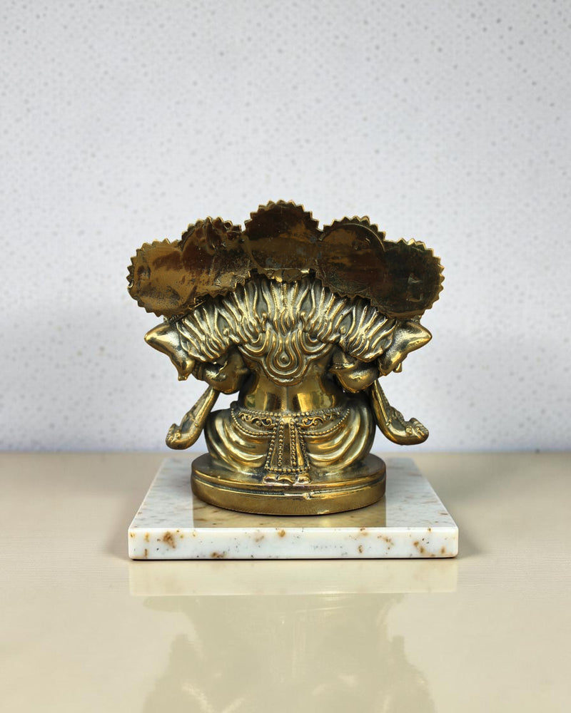 Rigvedaa™ Brass Panchmukhi Ganesha statue with five faces, intricate details, golden patina, on a marble base.