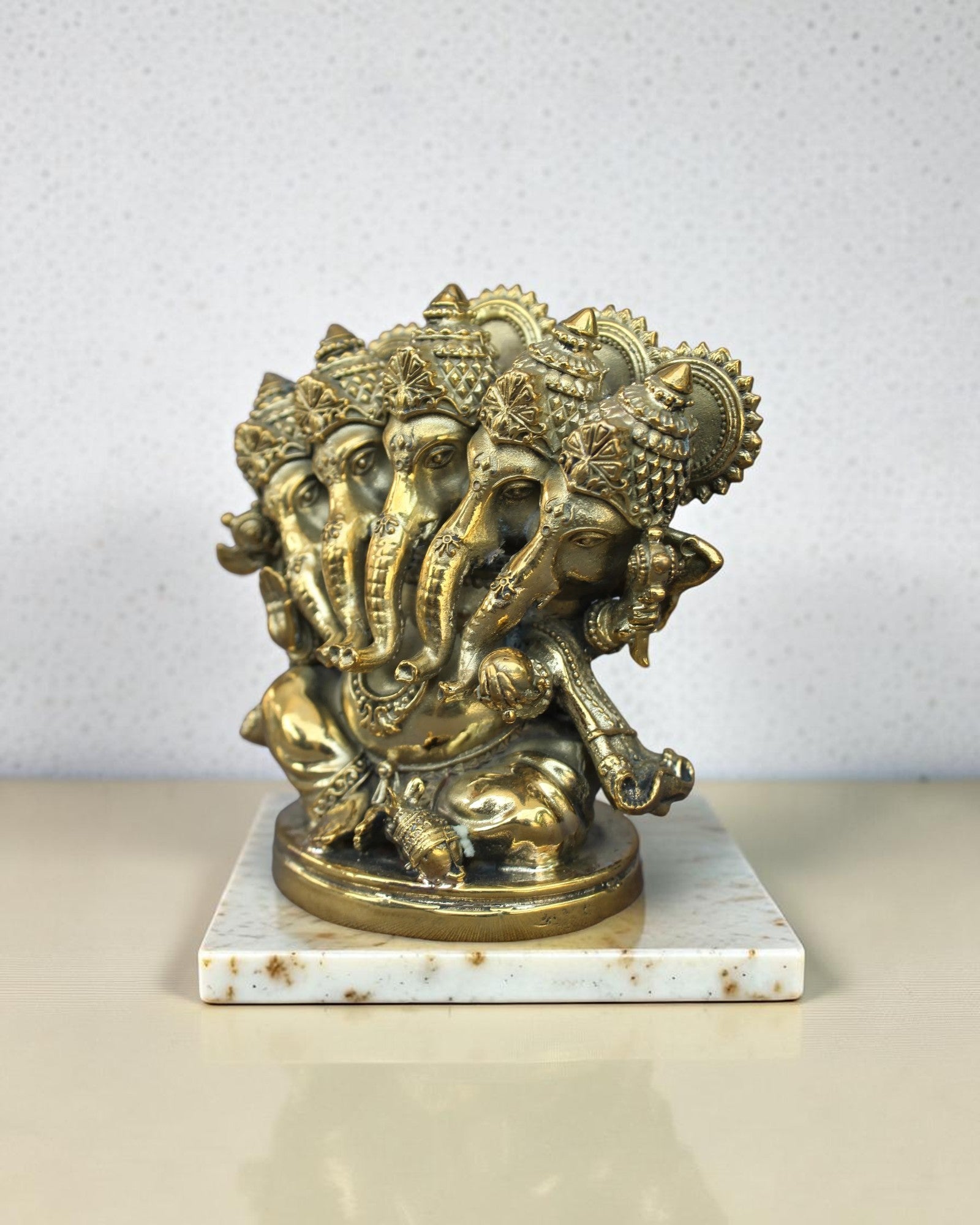 Rigvedaa™ Brass Panchmukhi Ganesha statue, five-faced Vinayaka Murti, ornate pedestal, golden patina, intricate details.