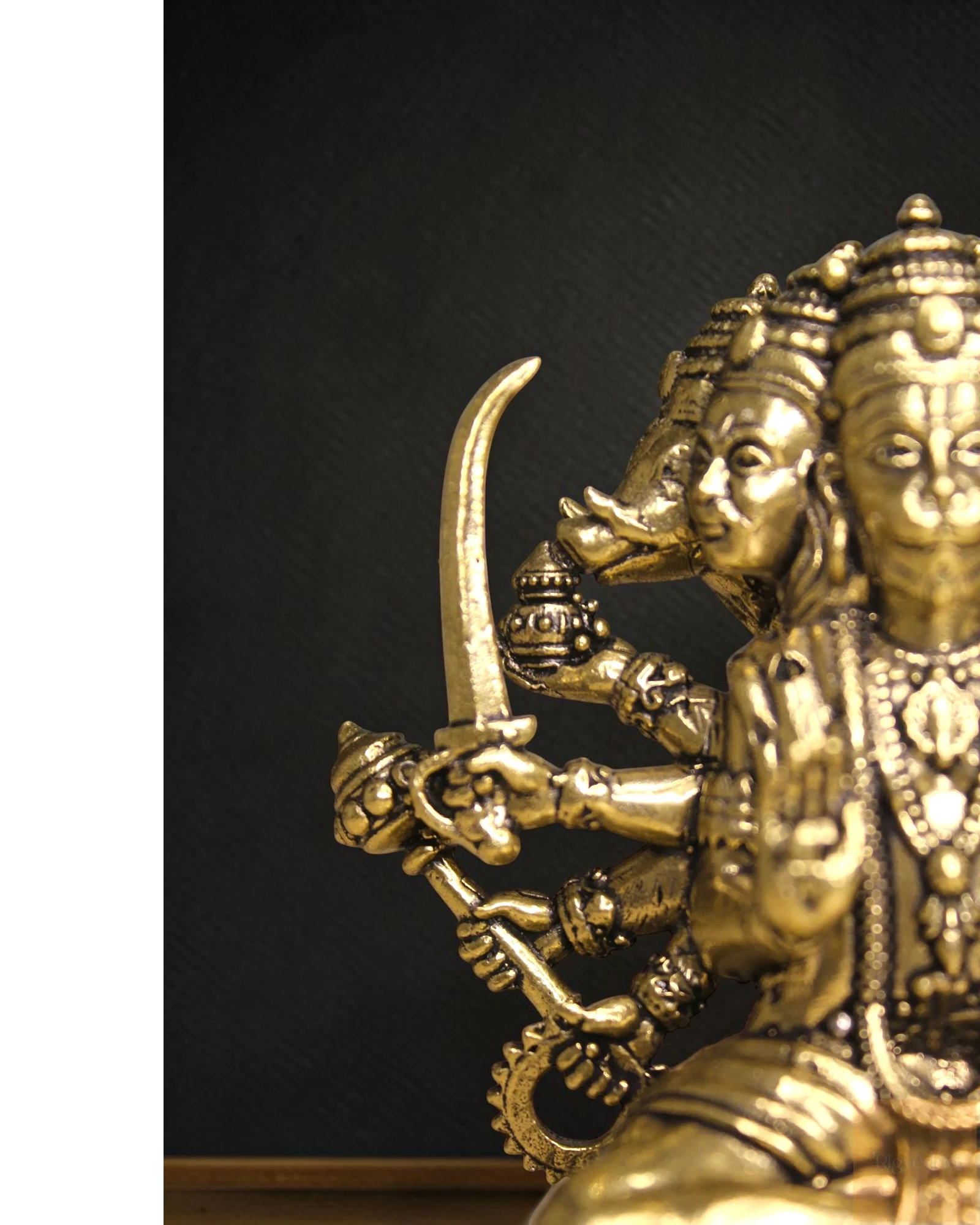Rigvedaa™ brass Panchmukhi Balaji idol, a five-faced Hanuman statue with sword and divine adornments, seated in a protective posture.