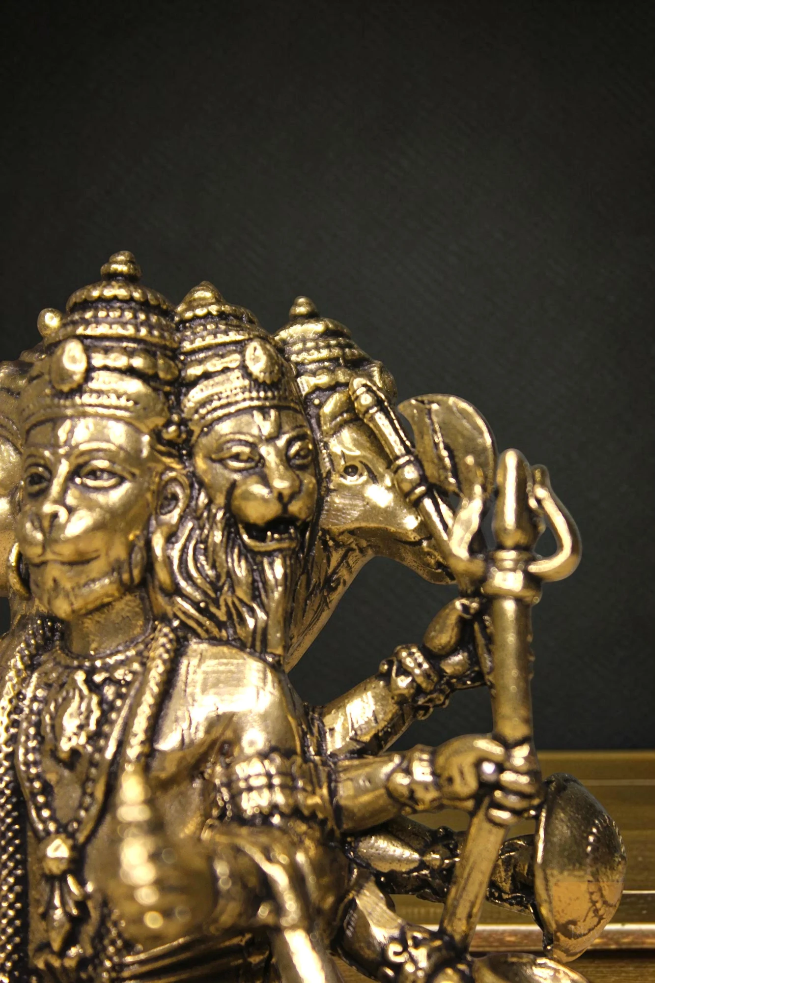 Rigvedaa brass Panchmukhi Balaji idol, a five-faced Hanuman statue in a sitting posture, holding a mace and shield.