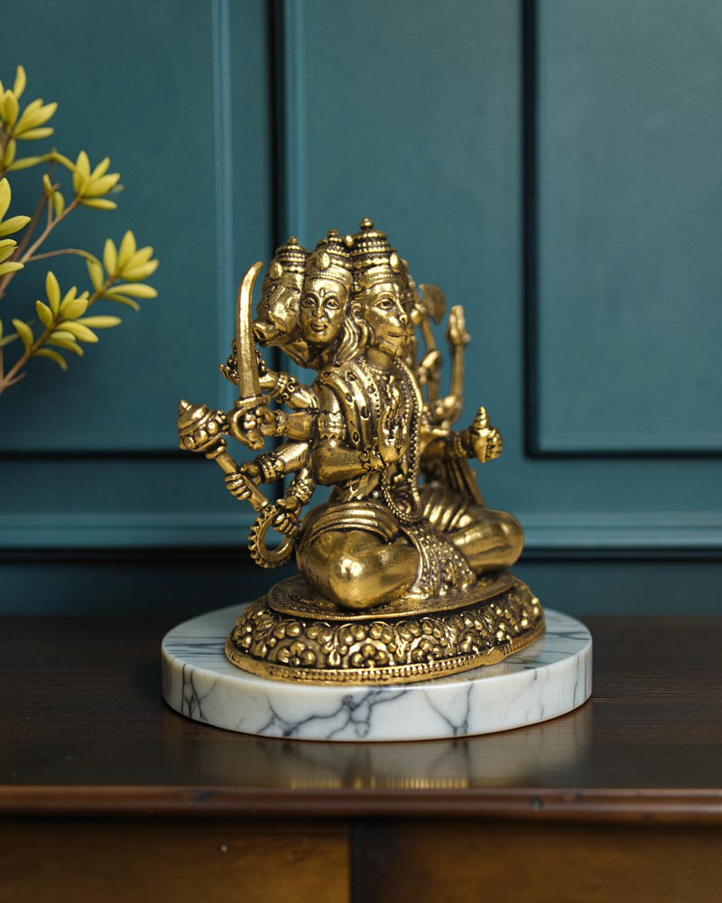 Rigvedaa™ Brass Sitting Panchmukhi Hanuman Statue with five faces and multiple arms, holding weapons, on a marble base.