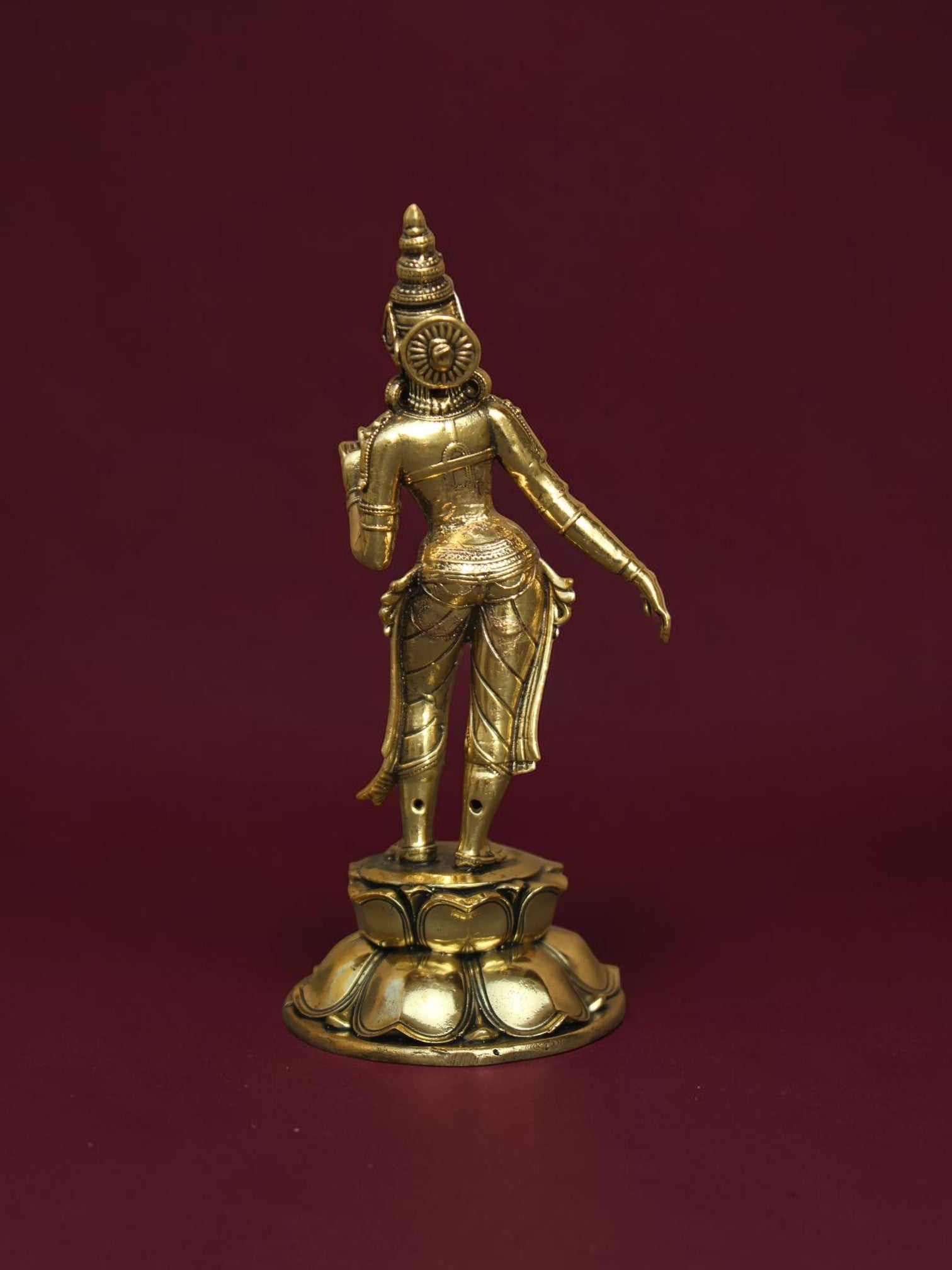 Back view of a Rigvedaa™ brass Goddess Parvati idol standing on a detailed lotus base with intricate traditional carving.