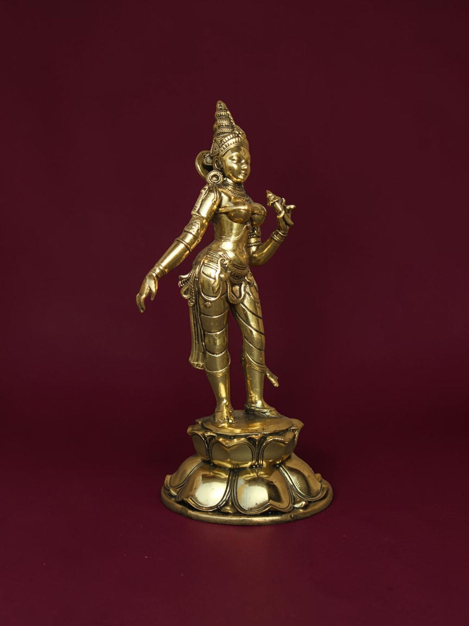 Rigvedaa™ brass Goddess Parvati idol standing on a detailed lotus base with intricate jewelry and golden finish.