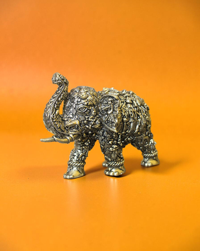 Rigvedaa
™ brass elephant statue with intricate Radha Krishna murals, golden patina, and raised trunk.
