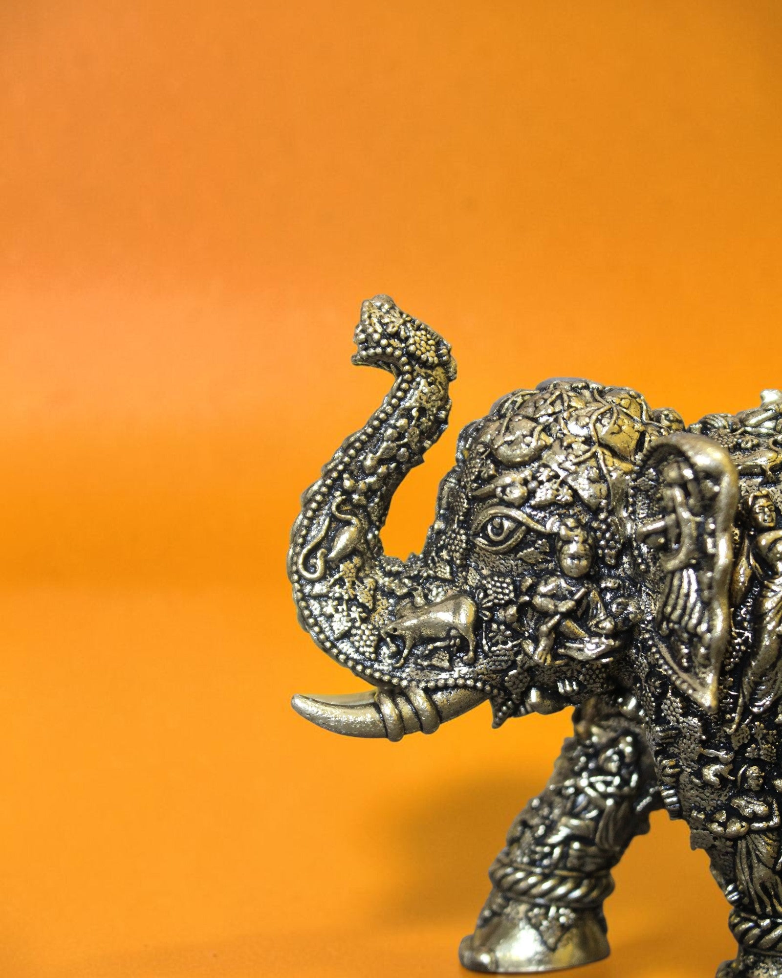 Rigvedaa™ brass elephant statue with Radha Krishna murals, intricate details, and antique golden finish.