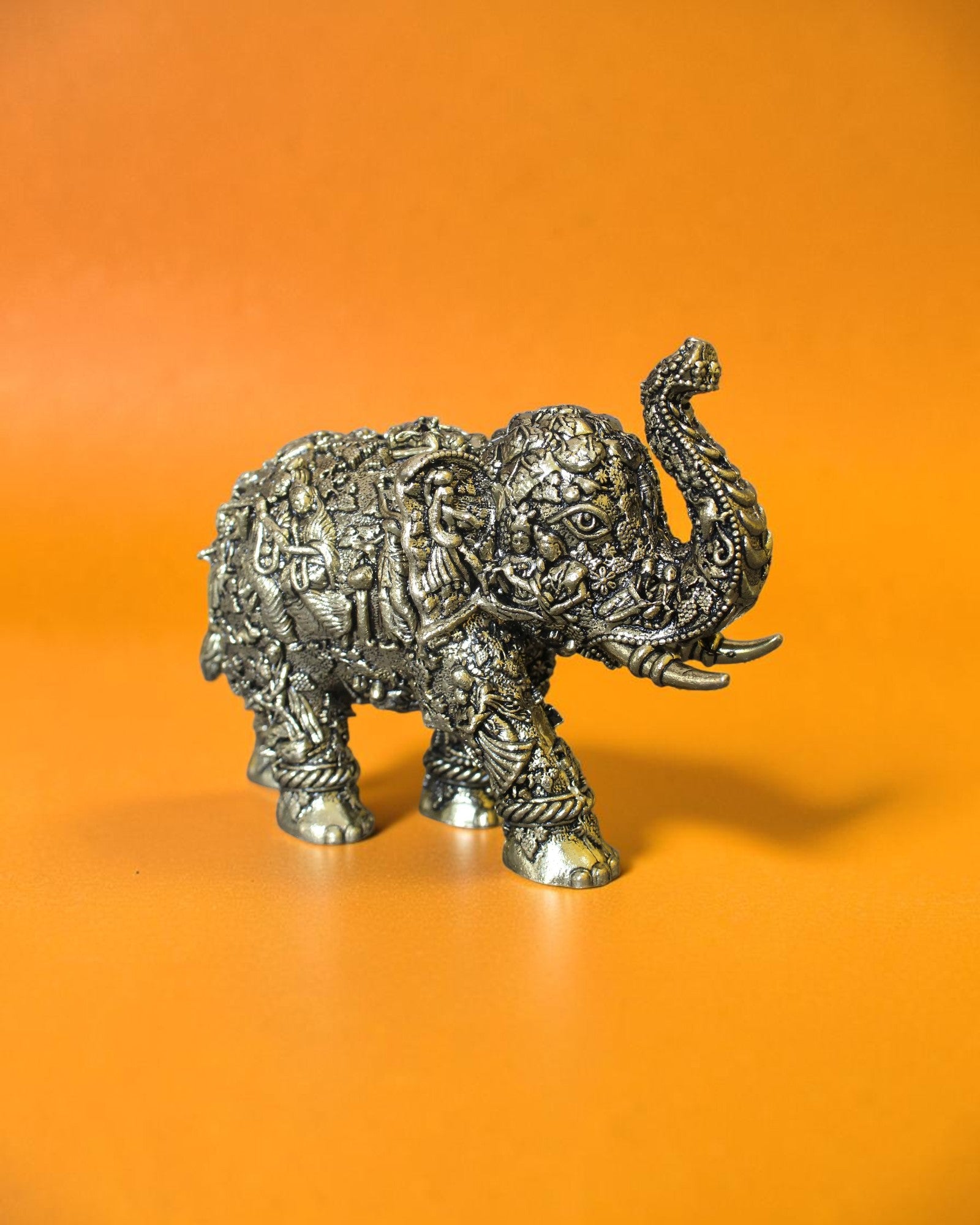 Rigvedaa™ brass elephant statue with intricate Radha Krishna murals, antique gold finish, decorative home decor.