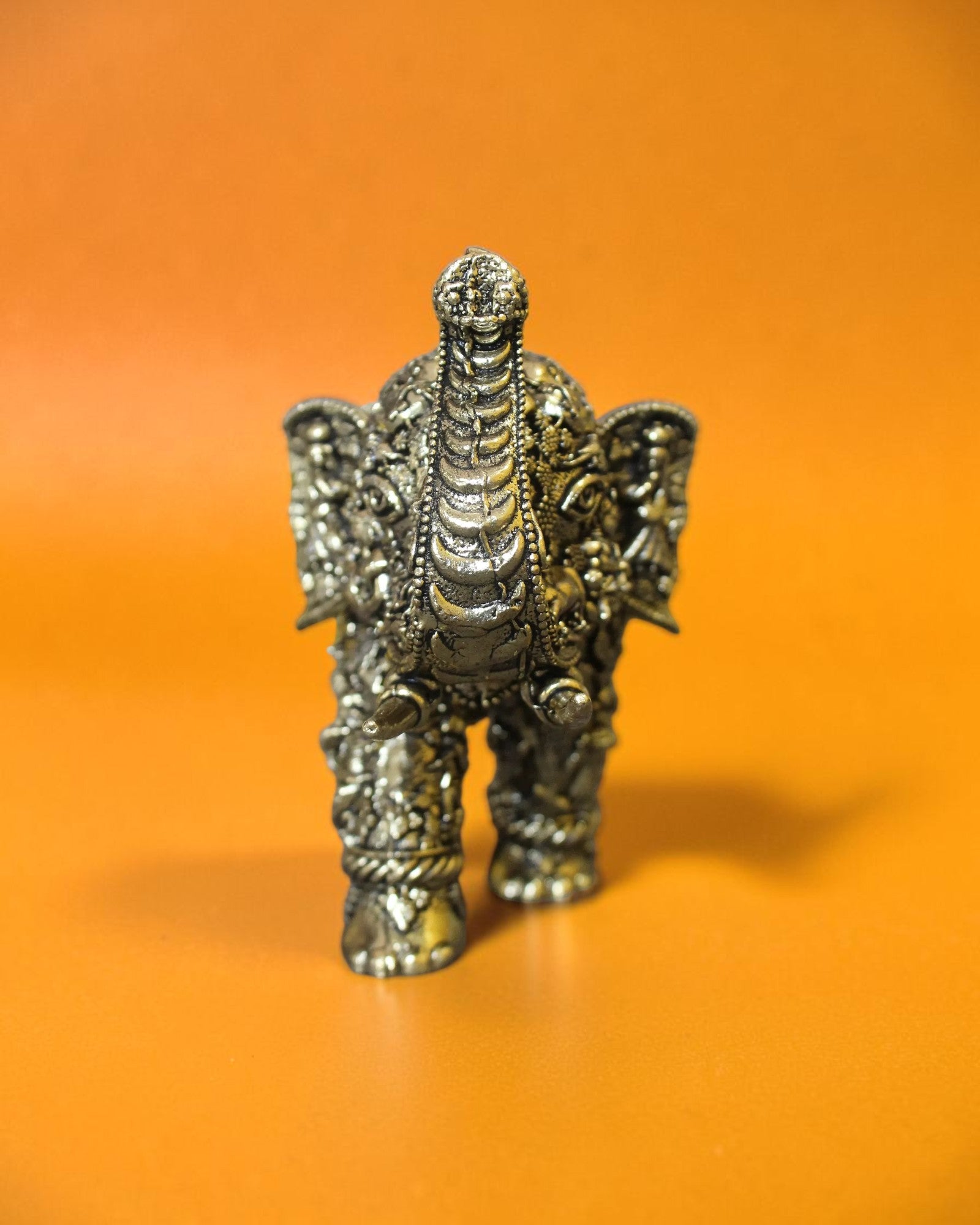 Rigvedaa™ brass elephant statue with intricate Radha Krishna murals, golden patina, and raised trunk.