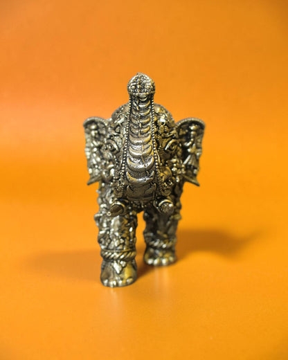 Rigvedaa™ brass elephant statue with intricate Radha Krishna murals, golden patina, and raised trunk.