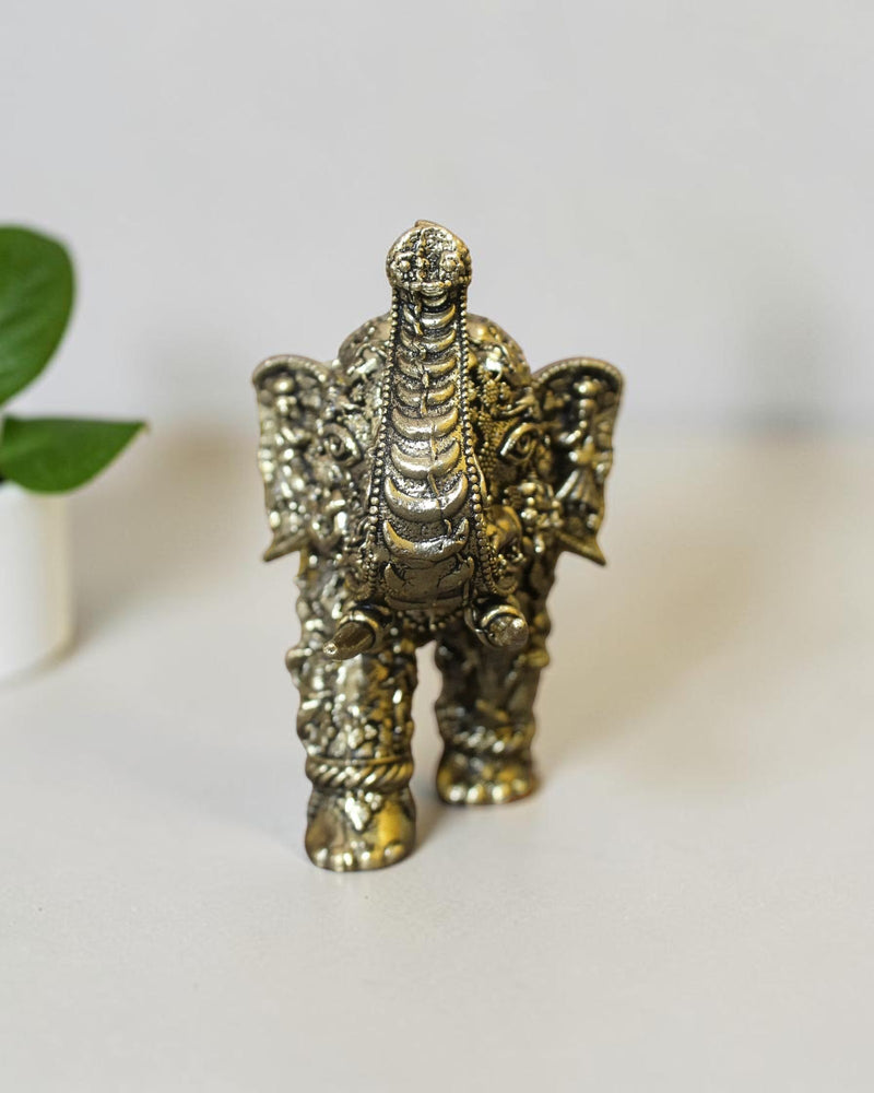 Rigvedaa™ brass elephant statue featuring intricate hand-carved Radha Krishna murals and a polished golden patina.