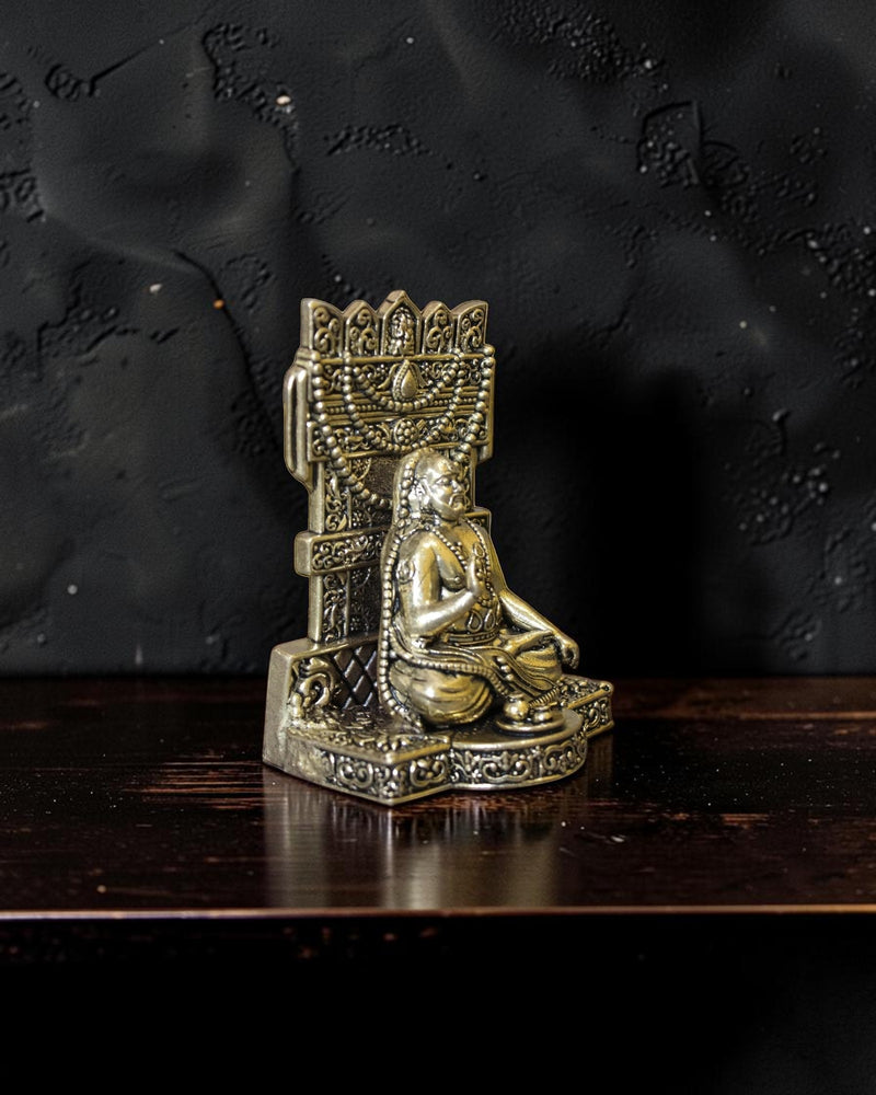 Rigvedaa™ Brass Raghavendra Swamy idol in seated posture with intricate detailing, adorned with beaded necklaces. Ideal for puja rooms.