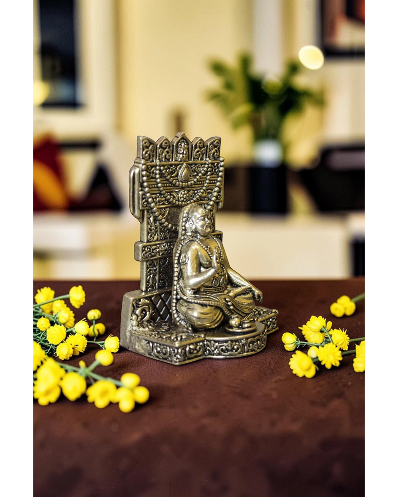 Rigvedaa™ Brass Raghavendra Swamy idol in seated posture with intricate detailing, adorned with beaded necklaces. Ideal for puja rooms.