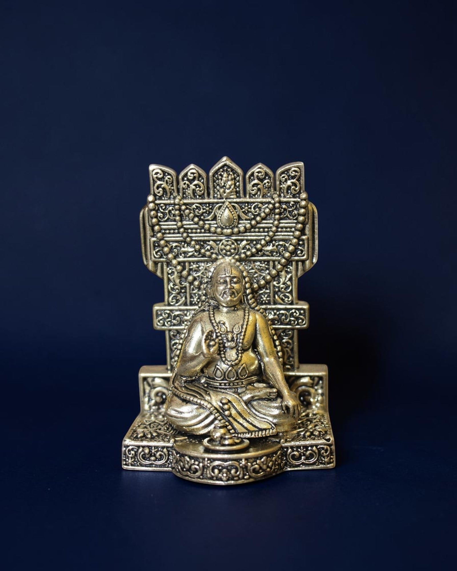 Rigvedaa™ brass Guru Raghavendra Swamy idol in a traditional seated posture with intricate decorative backrest