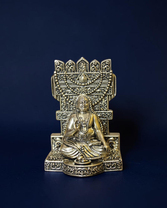 Rigvedaa™ brass Guru Raghavendra Swamy idol in a traditional seated posture with intricate decorative backrest