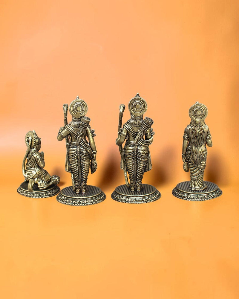 Rigvedaa™ Brass Ram Darbar statue set featuring Rama, Sita, Lakshmana, and Hanuman in traditional attire with intricate detailing. Rama holds a bow, Sita radiates grace, Lakshmana stands beside them, and Hanuman kneels in devotion.