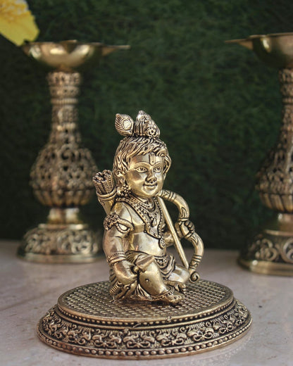 Rigvedaa™ handcrafted brass Ram Lalla idol featuring intricate details of Bal Ram with a bow on a decorative base.