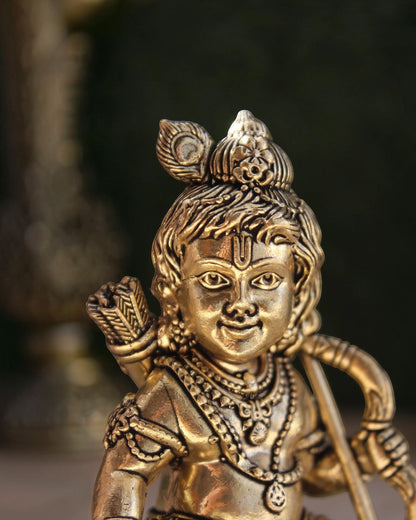 Close-up of a Rigvedaa™ brass Ram Lalla idol featuring intricate crown details, jewelry, and a serene facial expression.
