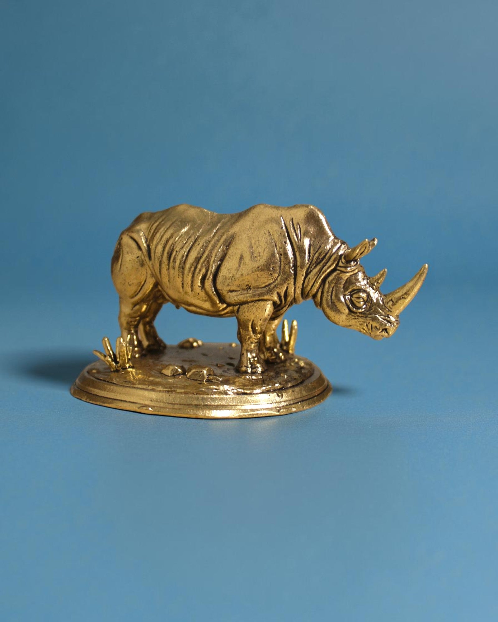 Rigvedaa™ brass rhinoceros statue, 3.25-inch, golden patina, detailed armor skin, Vastu and Feng Shui protection and wealth symbol.