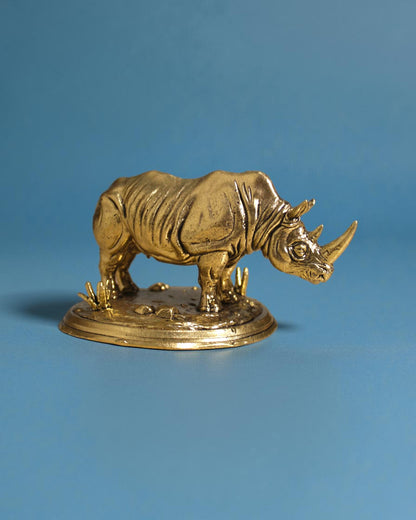 Rigvedaa™ brass rhinoceros statue, 3.25-inch, golden patina, detailed armor skin, Vastu and Feng Shui protection and wealth symbol.