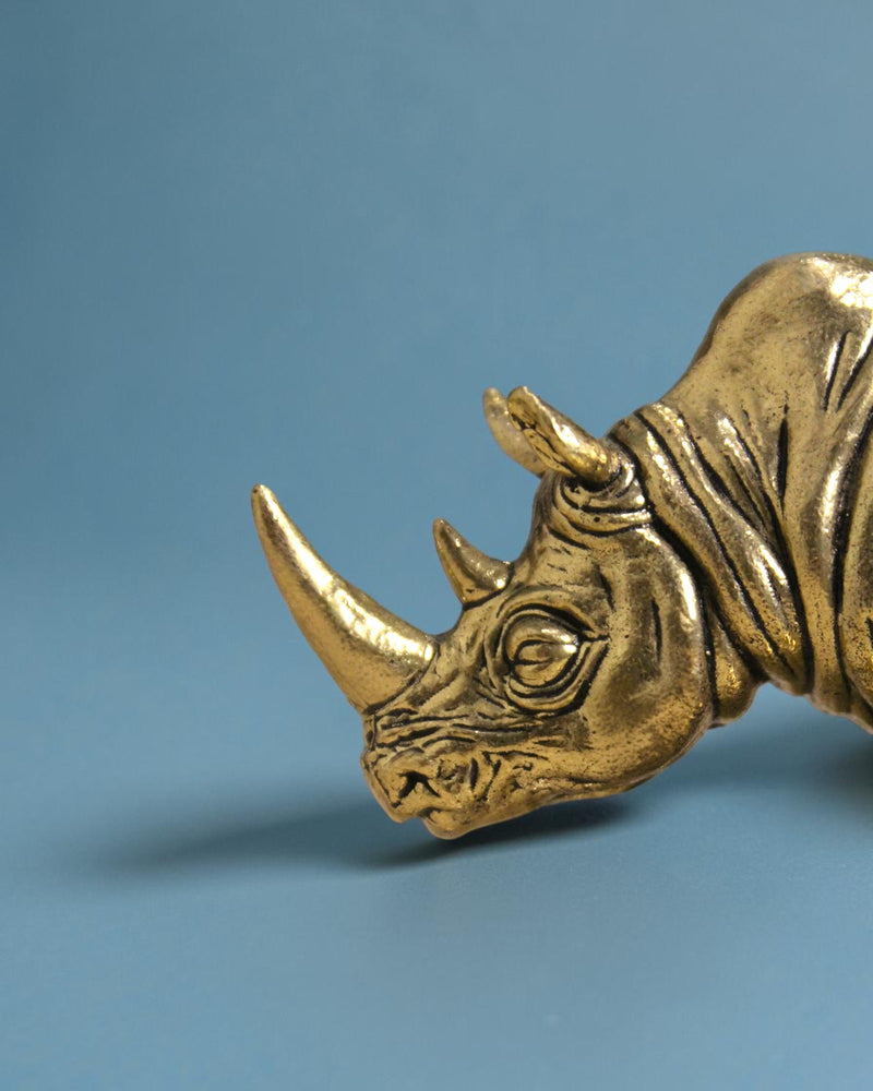 Rigvedaa™ Brass rhinoceros statue, 3.25-inch, golden patina, detailed armor skin, symbol of protection and wealth.