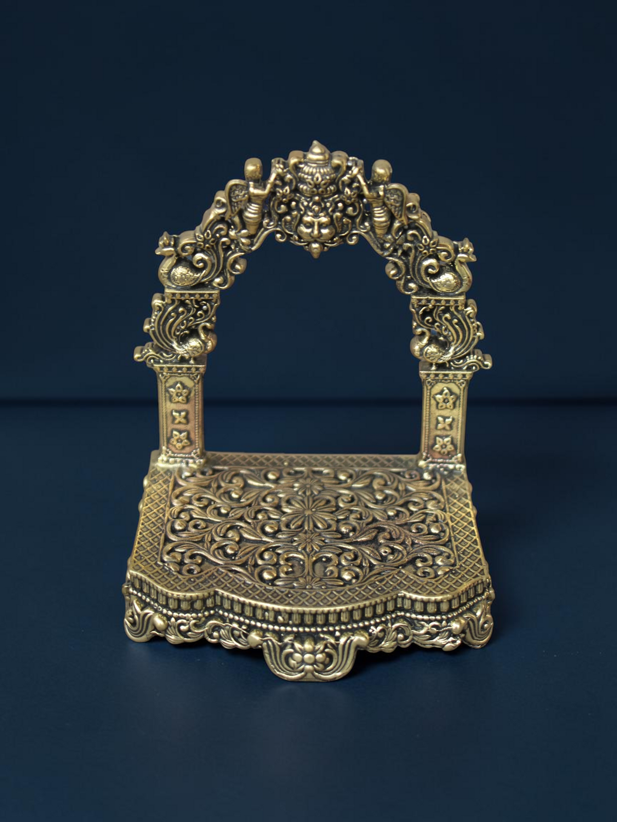 Rigvedaa™ brass Singhasan throne with ornate Prabhavali arch and intricate floral carvings for deity idols