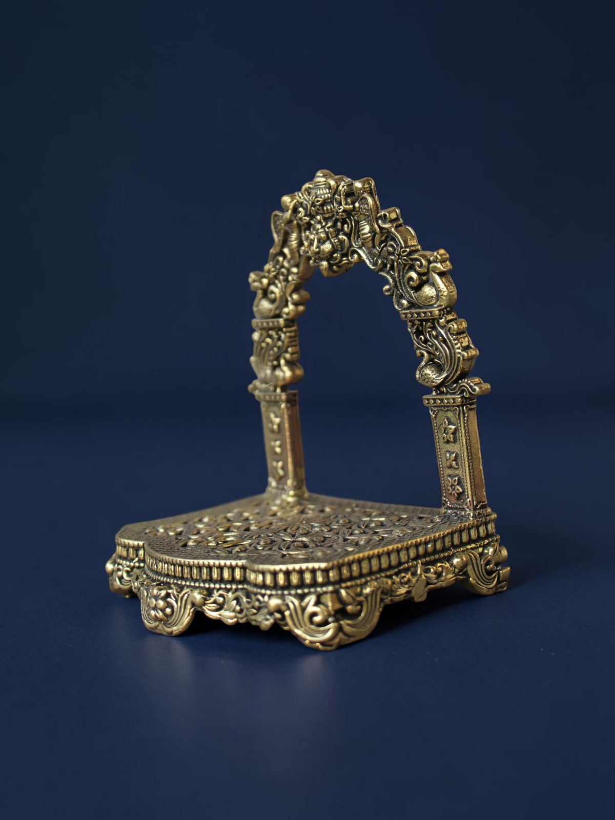 Rigvedaa™ brass Singhasan throne with intricate Prabhavali arch and floral embossed pedestal for deity idols