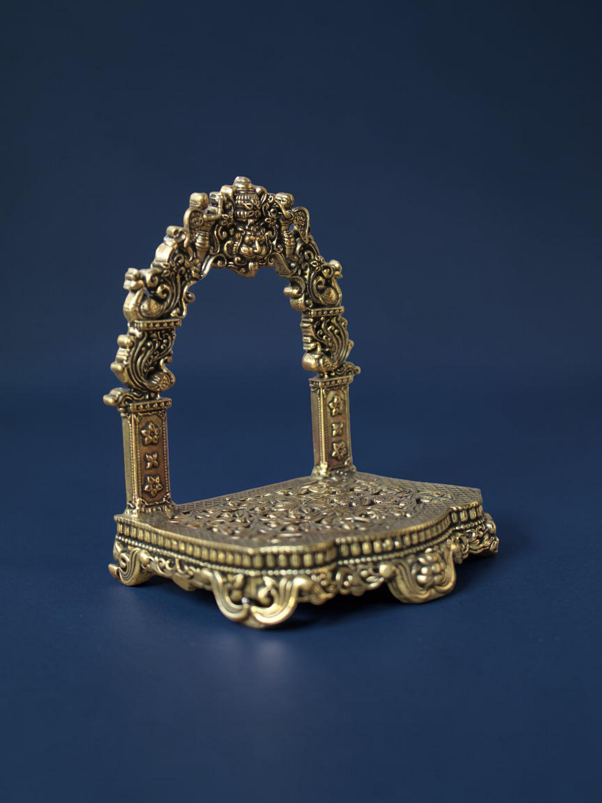 Rigvedaa™ brass Singhasan throne with ornate Prabhavali arch and floral embossed base for deity idols