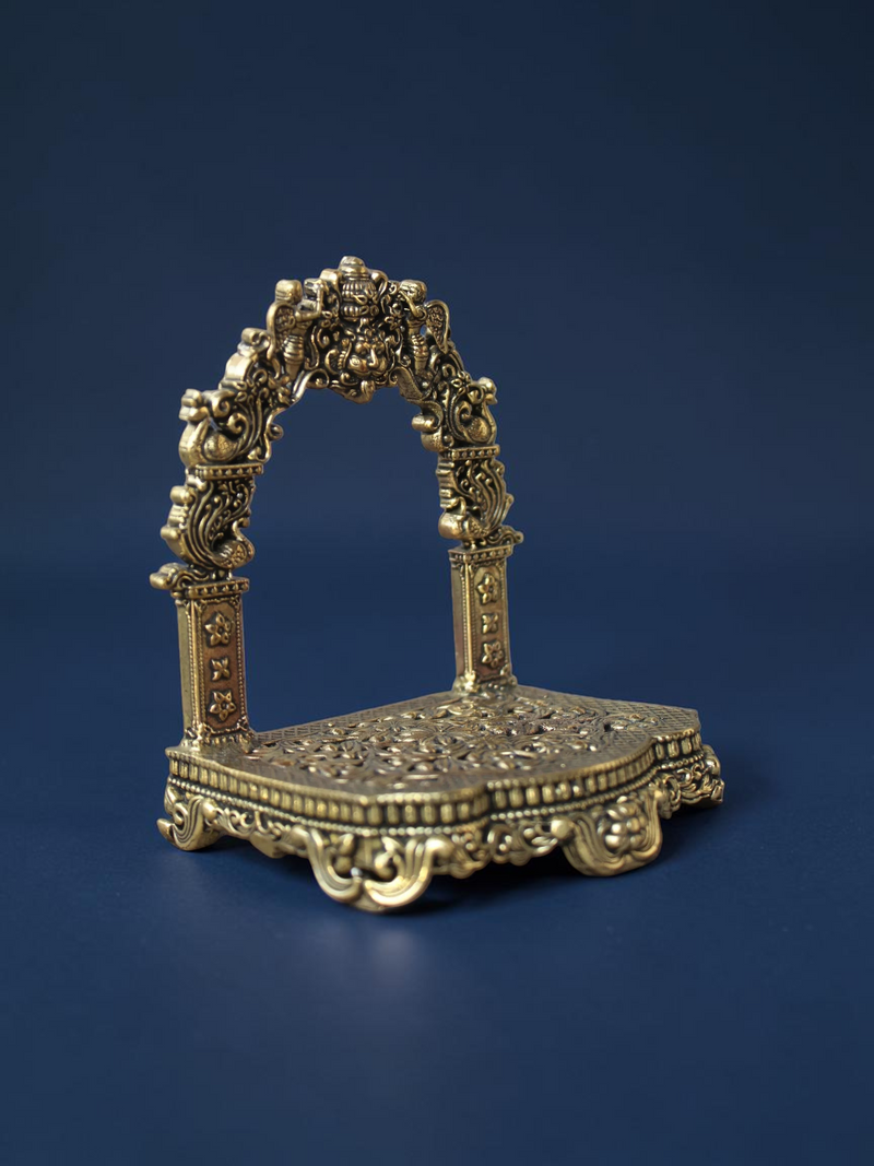 Rigvedaa™ brass Singhasan throne with ornate Prabhavali arch and floral embossed base for deity idols