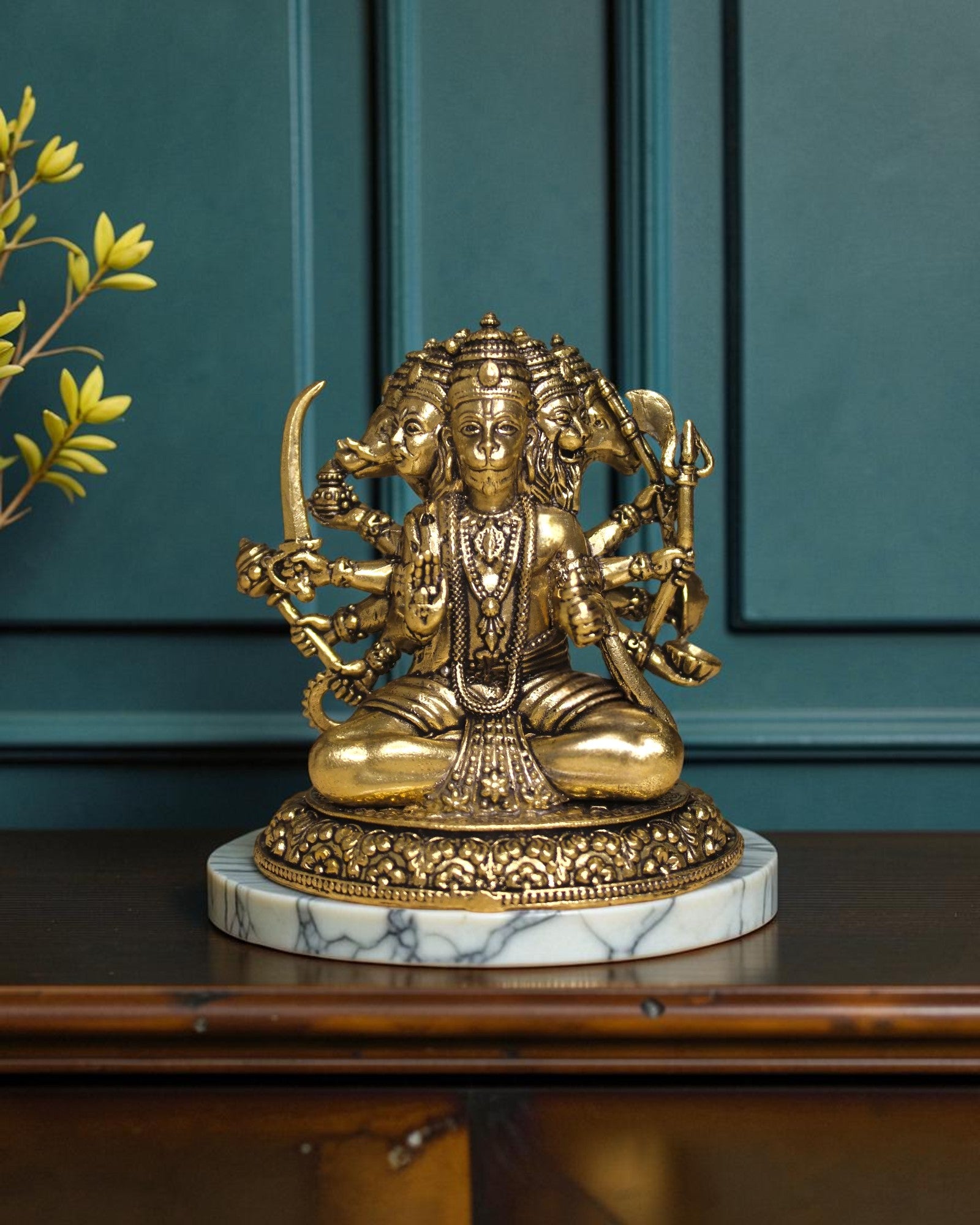 Rigvedaa™ Brass Sitting Panchmukhi Hanuman Statue with five faces, holding weapons, on a marble base.