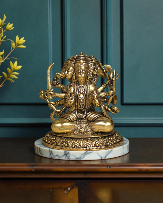 Rigvedaa™ Brass Sitting Panchmukhi Hanuman Statue with five faces, holding weapons, on a marble base.