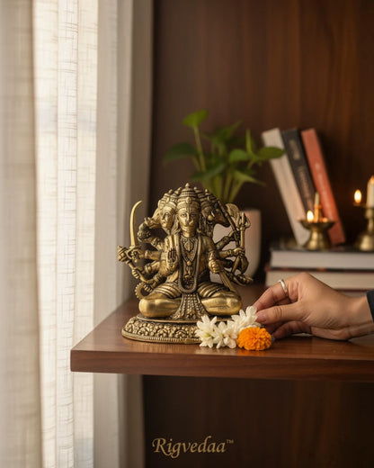 Rigvedaa™ brass sitting Panchmukhi Hanuman statue with five faces and multiple arms holding weapons, detailed golden finish.
