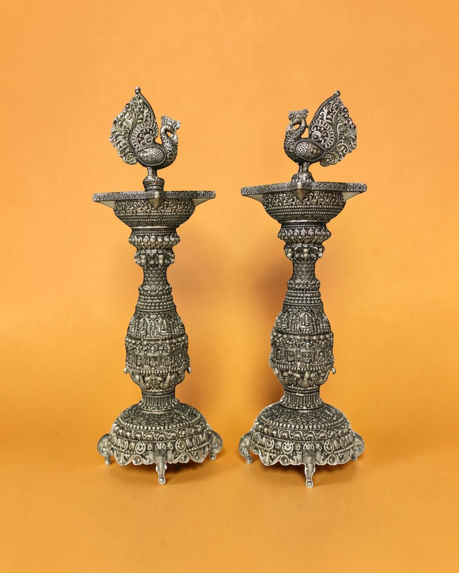 Rigvedaa pair of antique brass swan diyas with intricate carvings, 12 inches tall, perfect for pooja and festivals.
