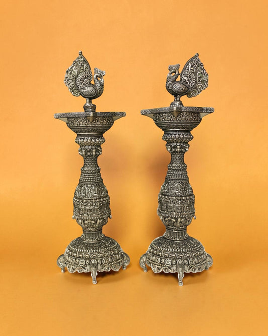 Rigvedaa pair of antique brass swan diyas with intricate carvings, 12 inches tall, perfect for pooja and festivals.