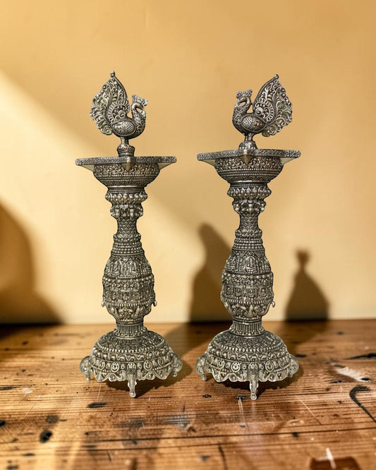 Rigvedaa pair of antique brass swan diyas with intricate carvings, 12 inches tall, perfect for pooja and festivals.