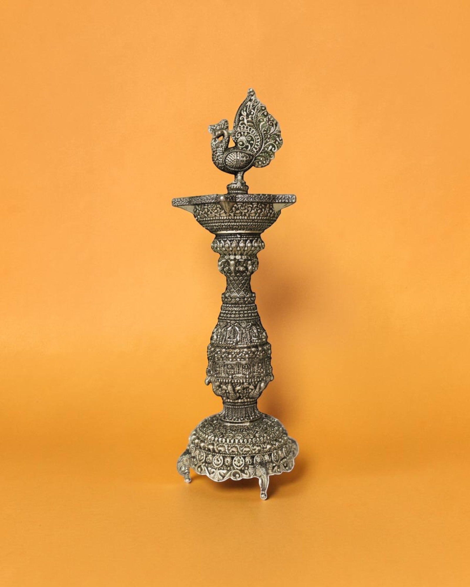 Rigvedaa brass swan diya stand with intricate carvings and antique gold finish, 12 inches tall, ideal for pooja and festivals.