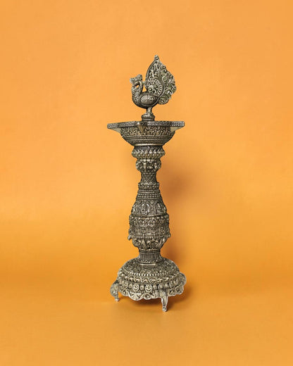 Rigvedaa brass swan diya stand with intricate carvings and antique gold finish, 12 inches tall, ideal for pooja and festivals.