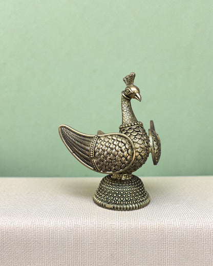 Rigvedaa™ brass swan statue with intricately carved fan wings and textured base. Golden patina finish.