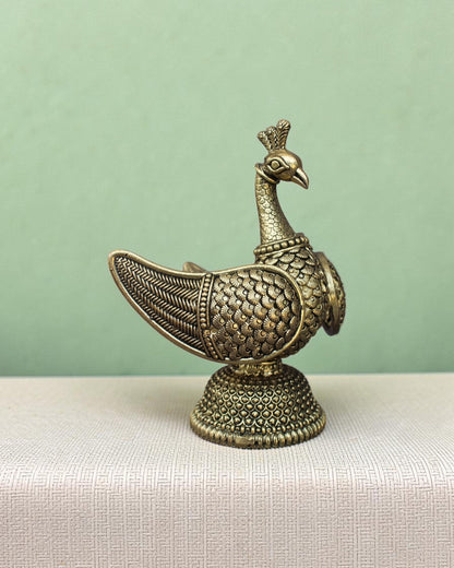 Rigvedaa™ handcrafted brass swan statue with intricately carved fan wings and detailed base. Golden patina finish.
