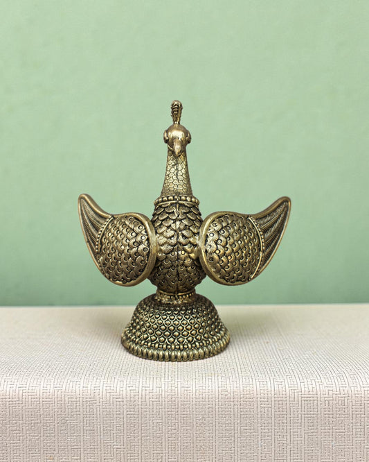 Rigvedaa™ brass swan statue with intricately carved fan wings and textured base. Golden patina finish.