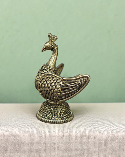 Rigvedaa™ handcrafted brass swan statue with carved fan wings and intricate base. Golden patina finish.