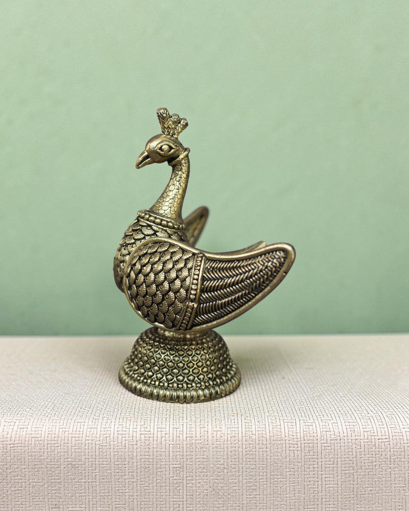 Rigvedaa™ handcrafted brass swan statue with carved fan wings and intricate base. Golden patina finish.