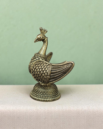 Rigvedaa™ handcrafted brass swan statue with carved fan wings and intricate base. Golden patina finish.