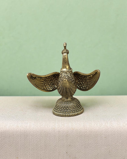 Rigvedaa™ handcrafted brass swan statue with carved fan wings and intricate base. Golden patina.