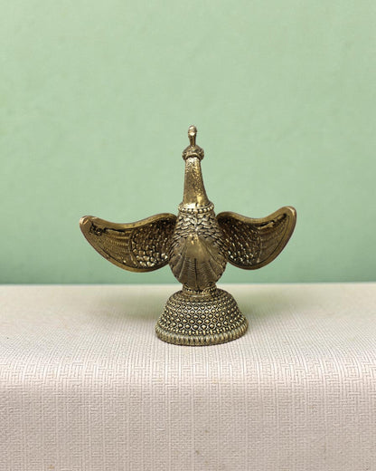 Rigvedaa™ handcrafted brass swan statue with carved fan wings and intricate base. Golden patina.