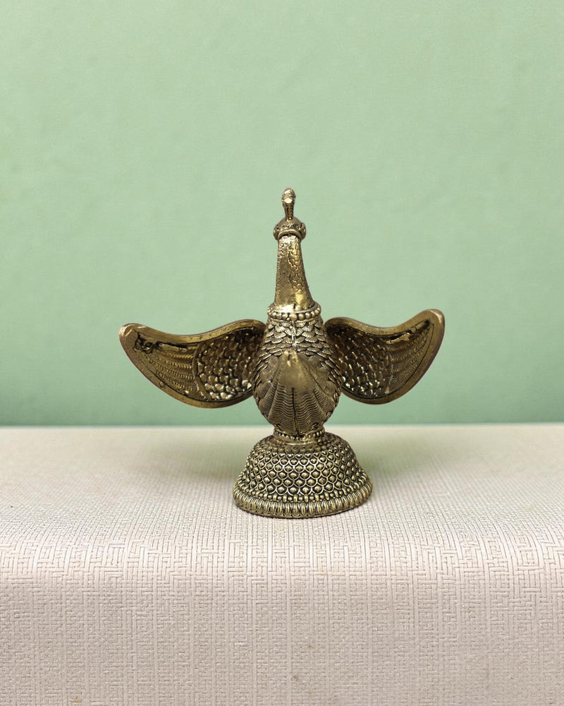 Rigvedaa™ handcrafted brass swan statue with carved fan wings and intricate base. Golden patina.